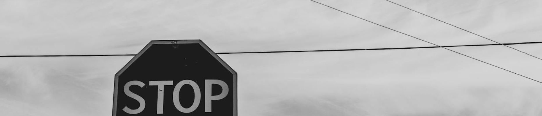 Black and white photo of a stop sign for blog on breaking the cycle of people pleasing