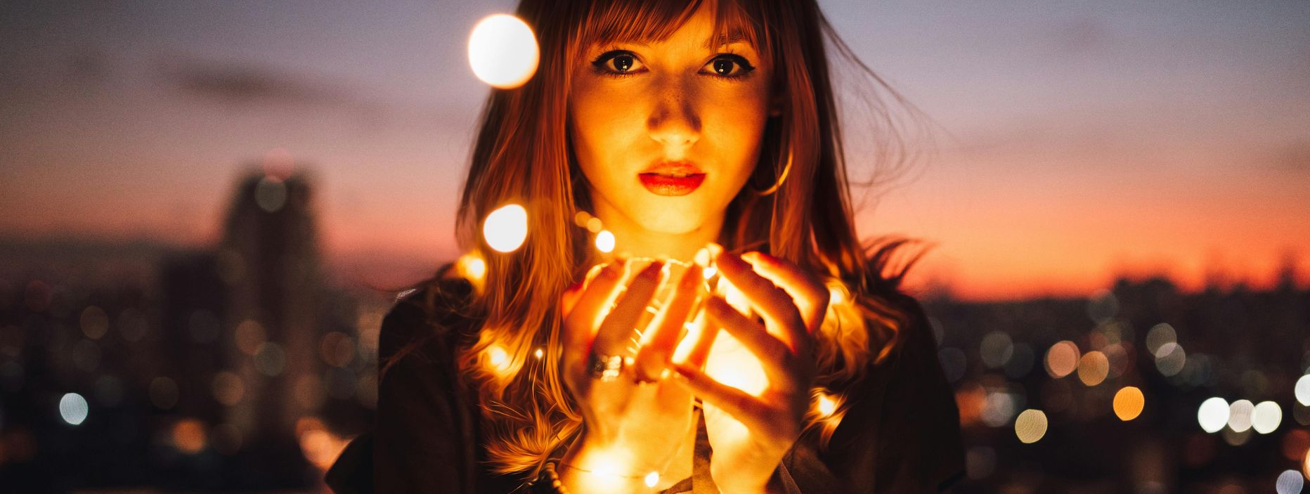 Image of female with cupped hands in front of her and light orbs coming from her hands, for Treatment for OCD