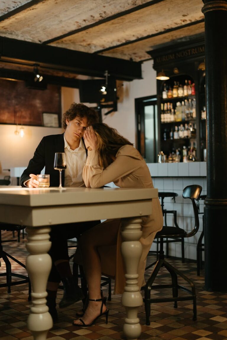 A couple in a restaurant having a tense moment, expressing emotion and stress for blog post on anxiety in romantic relationships