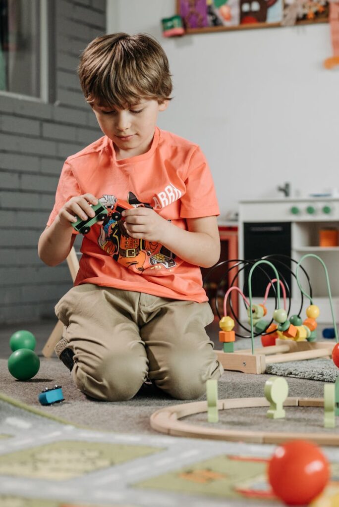 Child playing with colorful toys in a cozy play therapy room representing how to find a play therapist for your child blog post.