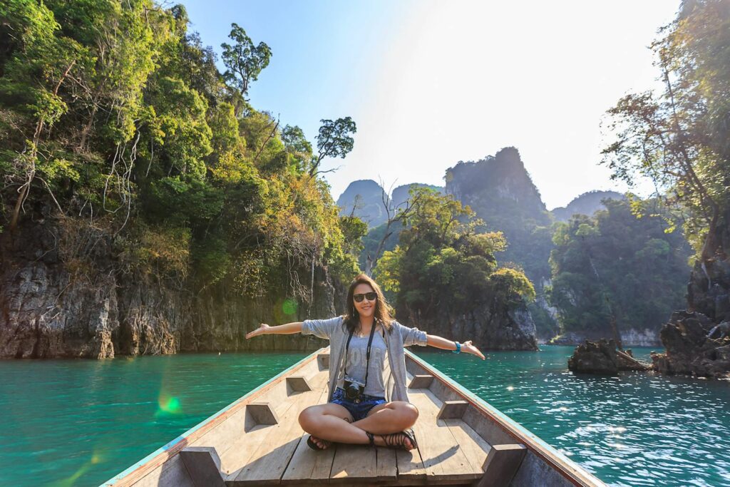 Photo by Te lensFix Asian woman relishing a serene boat journey through a landscape for Judy Wang's Treatment for Trauma page. She offers EMDR Therapy for those located in Maryland, Nevada & South Carolina.