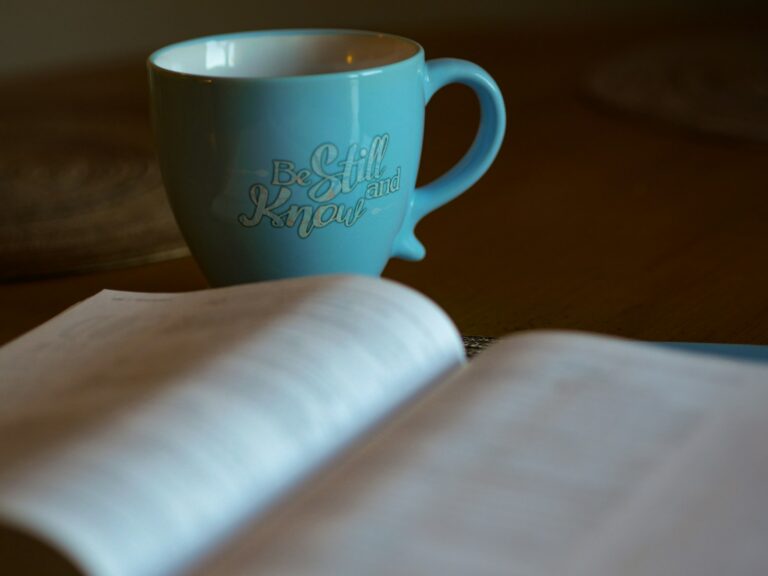 Photo by Aaron Burden shallow focus photography of open book beside blue ceramic cup for my approach to trauma page