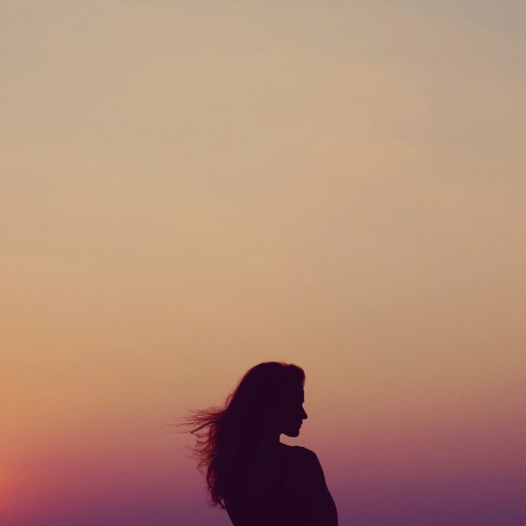 Photo by Ahmet Sali This silhouette of a woman beneath a warm, orange sky reflects the calm and focus EMDR Intensives offer.