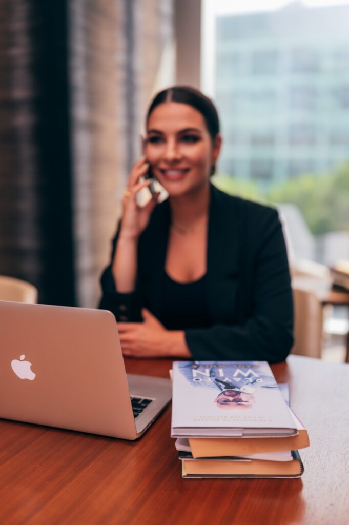 Photo by Paul White Woman in black blazer sitting by the table with macbook for treatment for trauma specialty page, providing EMDR therapy in Maryland, Nevada & South Carolina.