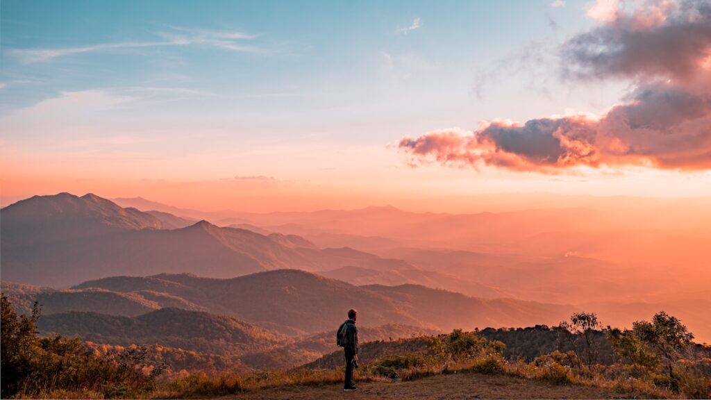 man standing on hill overlooking the sunset for Trauma therapy in Bethesda, Maryland