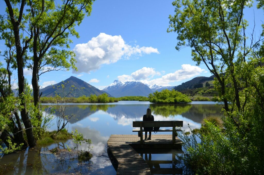 Photo by Robert Pearce woman sitting on bench near lake for trauma therapy in ellicott city, maryland webpage.