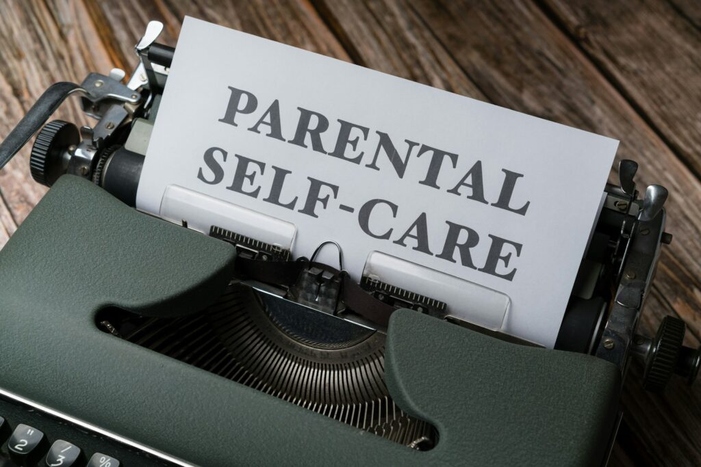 Photo by Markus Winkler a typewriter with a paper that reads parental self - care for parental anxiety blog post