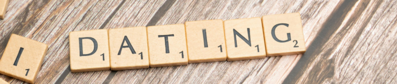 Scrabble tiles forming 'Dating' representing the fawn response triggered in people pleasers.