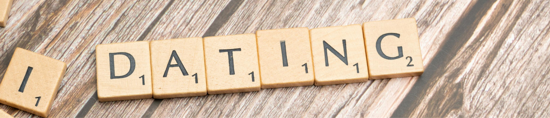 Scrabble tiles forming 'Dating' representing the fawn response triggered in people pleasers.